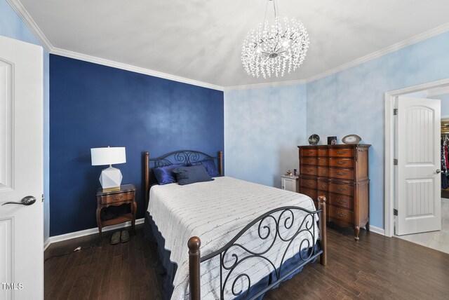 123 Turnstone Dr, Durham, NC 27703 - bedroom featuring hardwood / wood-style flooring, a chandelier, baseboards, and crown molding