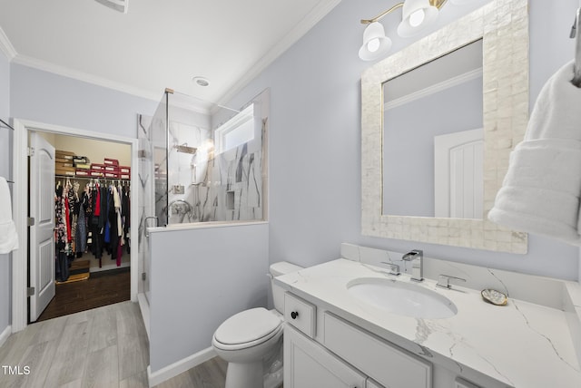 123 Turnstone Dr, Durham, NC 27703 - bathroom featuring ornamental molding, vanity, wood finished floors, a shower stall, and a walk in closet
