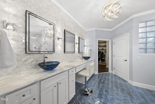 123 Turnstone Dr, Durham, NC 27703 - bathroom with double vanity, baseboards, ornamental molding, backsplash, and a spacious closet