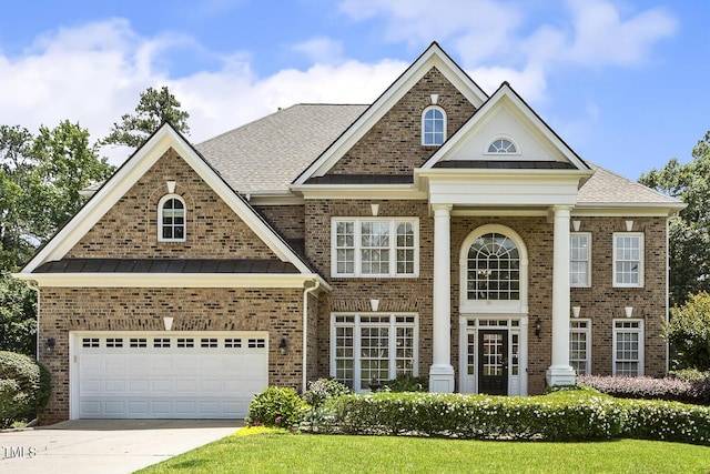 825 Highwater Pl, Fuquay Varina, NC 27526 - neoclassical / greek revival house featuring brick siding, driveway, a standing seam roof, and roof with shingles