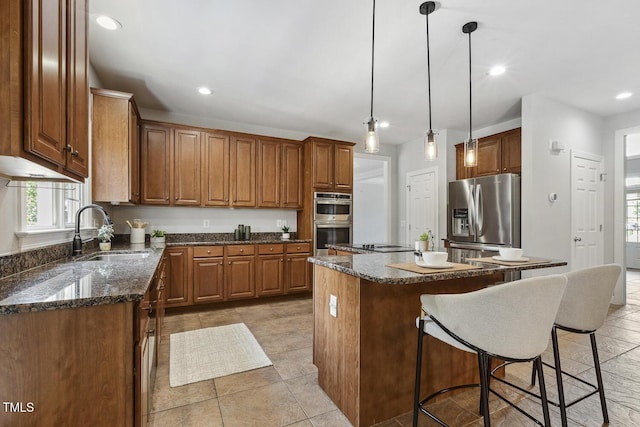 825 Highwater Pl, Fuquay Varina, NC 27526 - kitchen with appliances with stainless steel finishes, a center island, plenty of natural light, a breakfast bar, and recessed lighting