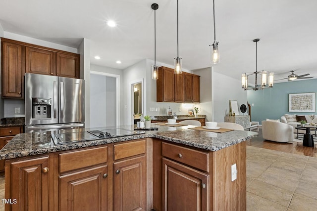 825 Highwater Pl, Fuquay Varina, NC 27526 - kitchen with stainless steel fridge, black electric cooktop, a kitchen island, open floor plan, and ceiling fan