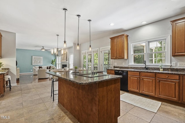 825 Highwater Pl, Fuquay Varina, NC 27526 - kitchen featuring black appliances, ceiling fan, open floor plan, a center island, and a breakfast bar
