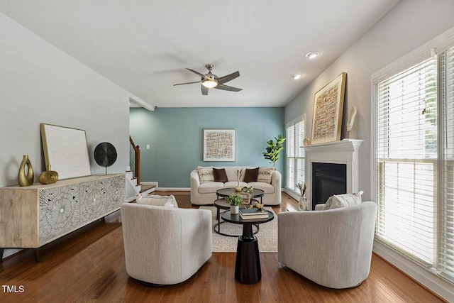 825 Highwater Pl, Fuquay Varina, NC 27526 - living room featuring stairway, a ceiling fan, wood finished floors, a glass covered fireplace, and recessed lighting