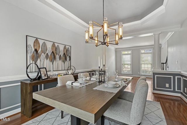 825 Highwater Pl, Fuquay Varina, NC 27526 - dining area featuring ornamental molding, wood finished floors, ornate columns, a raised ceiling, and a chandelier