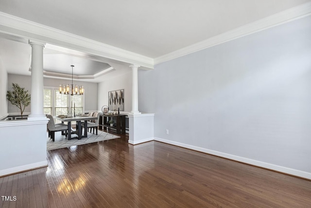 825 Highwater Pl, Fuquay Varina, NC 27526 - dining room featuring ornate columns, dark wood-type flooring, a tray ceiling, crown molding, and a chandelier