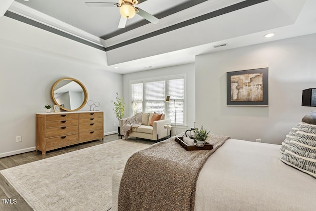 825 Highwater Pl, Fuquay Varina, NC 27526 - bedroom with wood finished floors, recessed lighting, ornamental molding, a tray ceiling, and ceiling fan