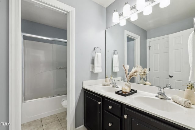 825 Highwater Pl, Fuquay Varina, NC 27526 - bathroom with double vanity, tile patterned floors, and bath / shower combo with glass door