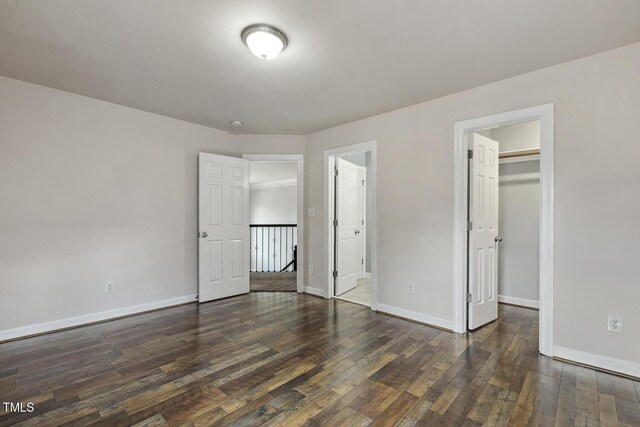 825 Highwater Pl, Fuquay Varina, NC 27526 - unfurnished bedroom featuring a walk in closet, wood finished floors, and a closet