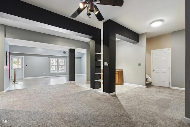 825 Highwater Pl, Fuquay Varina, NC 27526 - unfurnished living room with ceiling fan, stairway, and light carpet