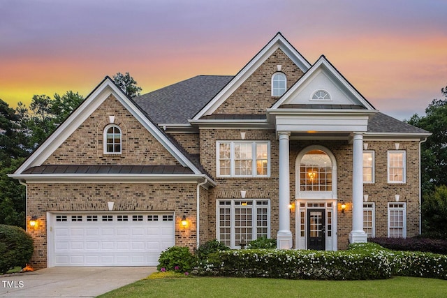 825 Highwater Pl, Fuquay Varina, NC 27526 - neoclassical home featuring brick siding, driveway, a standing seam roof, and a garage