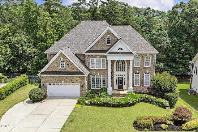 825 Highwater Pl, Fuquay Varina, NC 27526 - neoclassical / greek revival house featuring concrete driveway, brick siding, a garage, and roof with shingles