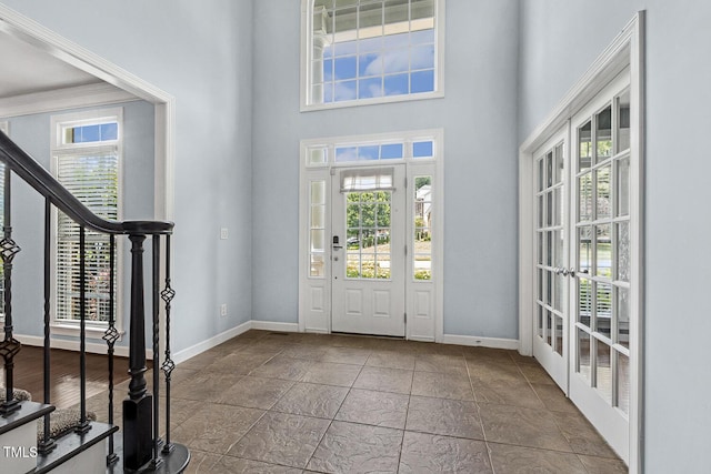 825 Highwater Pl, Fuquay Varina, NC 27526 - foyer featuring a towering ceiling, stairway, and french doors
