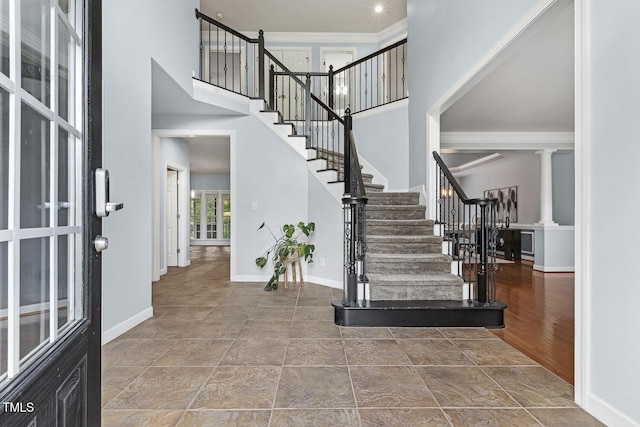 825 Highwater Pl, Fuquay Varina, NC 27526 - foyer featuring a towering ceiling, decorative columns, and stairs