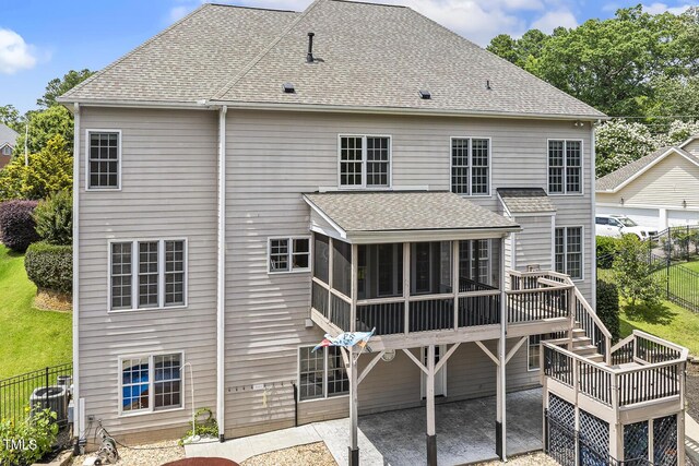 825 Highwater Pl, Fuquay Varina, NC 27526 - back of house featuring a sunroom, a patio, a shingled roof, stairs, and a wooden deck