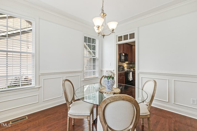 853 Bluffcreek Dr, Fuquay Varina, NC 27526 - dining room with a chandelier, a decorative wall, dark wood finished floors, a wainscoted wall, and ornamental molding
