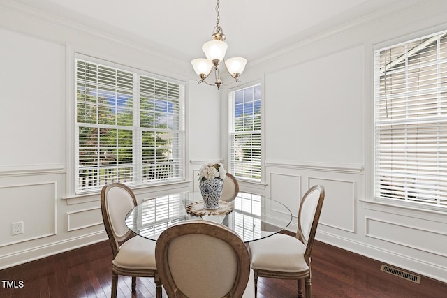 853 Bluffcreek Dr, Fuquay Varina, NC 27526 - dining room with a chandelier, a decorative wall, dark wood finished floors, wainscoting, and ornamental molding