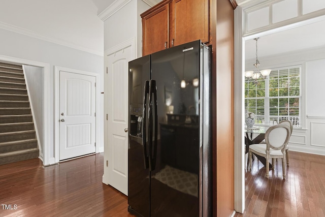 853 Bluffcreek Dr, Fuquay Varina, NC 27526 - kitchen with black fridge with ice dispenser, ornamental molding, brown cabinets, dark wood-type flooring, and a chandelier