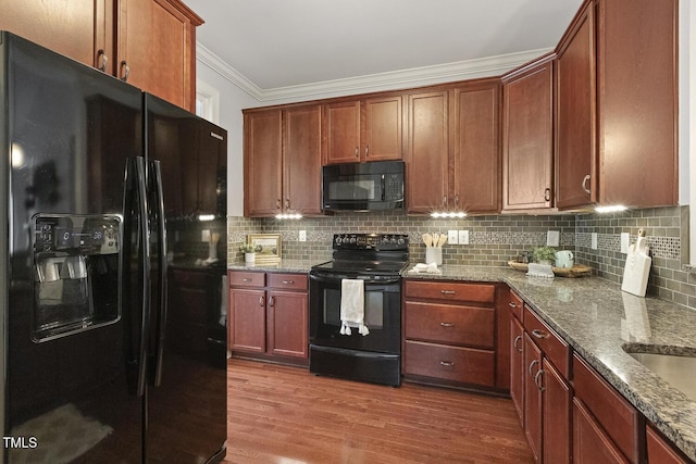 853 Bluffcreek Dr, Fuquay Varina, NC 27526 - kitchen featuring black appliances, crown molding, dark wood finished floors, decorative backsplash, and stone counters