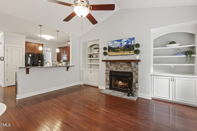853 Bluffcreek Dr, Fuquay Varina, NC 27526 - unfurnished living room featuring built in shelves, ceiling fan, dark wood-style floors, a stone fireplace, and high vaulted ceiling