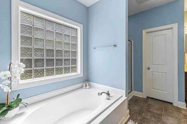 853 Bluffcreek Dr, Fuquay Varina, NC 27526 - full bathroom with a garden tub, plenty of natural light, tile patterned floors, and a stall shower