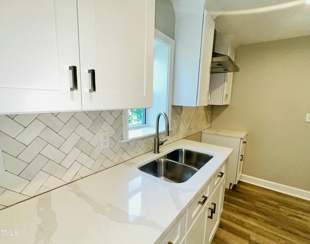 505 E Canary St, Dunn, NC 28334 - kitchen with a sink, light stone countertops, white cabinetry, tasteful backsplash, and baseboards