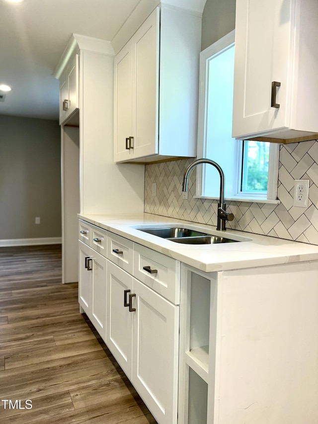 505 E Canary St, Dunn, NC 28334 - kitchen featuring a sink, backsplash, white cabinetry, wood finished floors, and recessed lighting