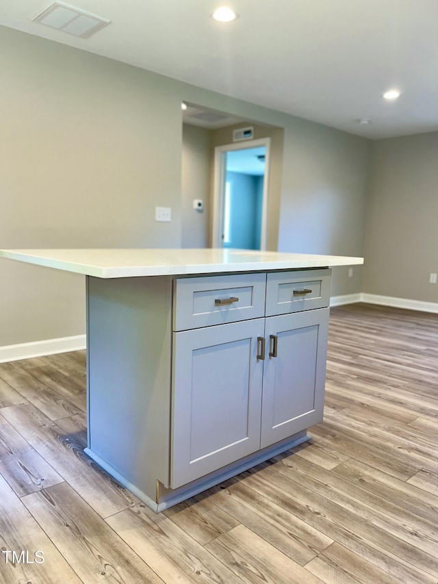 505 E Canary St, Dunn, NC 28334 - kitchen with light wood-style floors, gray cabinets, recessed lighting, a center island, and baseboards
