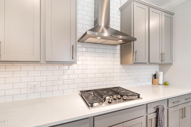 2128 Jollay St, Durham, NC 27703 - kitchen featuring wall chimney range hood, gray cabinets, stainless steel gas stovetop, light countertops, and decorative backsplash