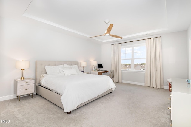 2128 Jollay St, Durham, NC 27703 - bedroom with a raised ceiling, baseboards, and light carpet