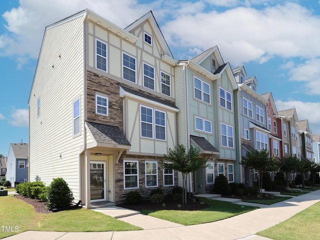 601 Grand Central Sta, Apex, NC 27502 - townhome / multi-family property featuring stone siding, a residential view, a front yard, and board and batten siding
