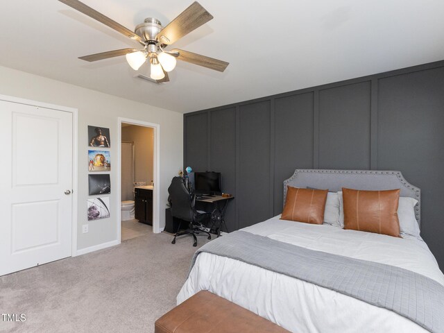 601 Grand Central Sta, Apex, NC 27502 - bedroom with a decorative wall, light carpet, ensuite bath, a desk, and a ceiling fan