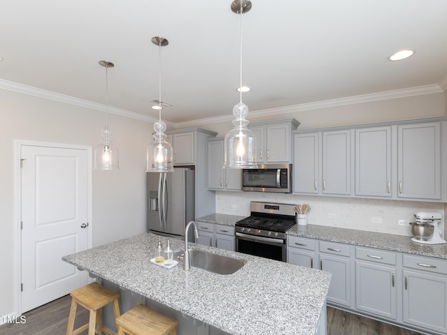 601 Grand Central Sta, Apex, NC 27502 - kitchen featuring appliances with stainless steel finishes, gray cabinetry, a sink, ornamental molding, and a breakfast bar area