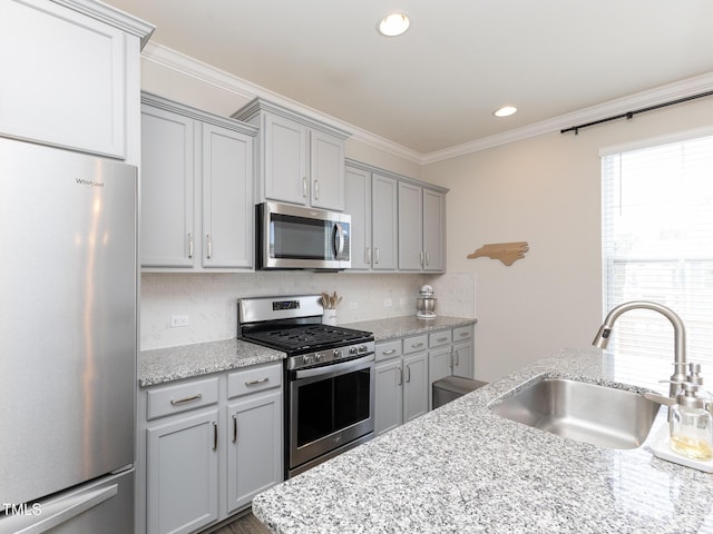 601 Grand Central Sta, Apex, NC 27502 - kitchen with stainless steel appliances, a sink, gray cabinetry, backsplash, and ornamental molding