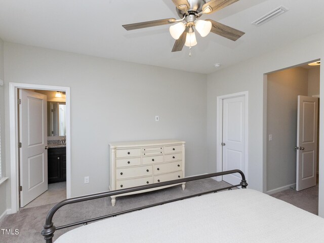601 Grand Central Sta, Apex, NC 27502 - bedroom with light colored carpet, baseboards, connected bathroom, and ceiling fan