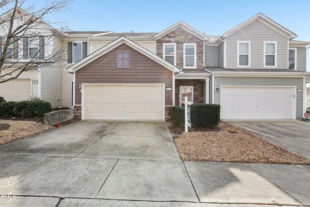 8204 Yaxley Hall Dr, Raleigh, NC 27616 - view of front of property featuring concrete driveway, an attached garage, and stone siding