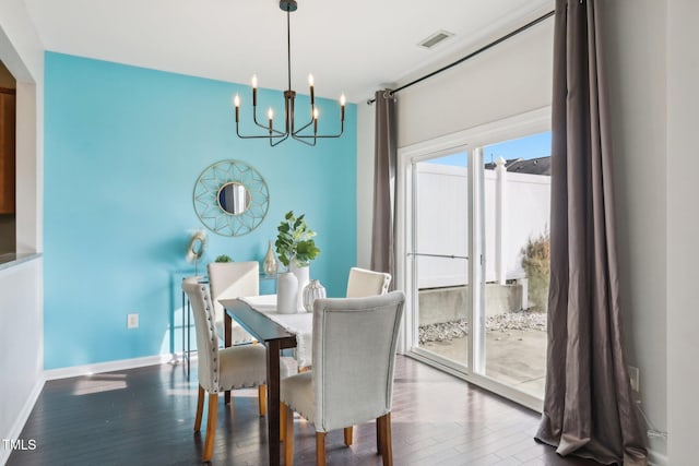 8204 Yaxley Hall Dr, Raleigh, NC 27616 - dining room with a chandelier, wood finished floors, and baseboards