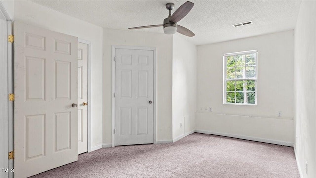 2396 Spring Valley Rd, Henderson, NC 27537 - unfurnished bedroom featuring carpet, a textured ceiling, baseboards, and a ceiling fan