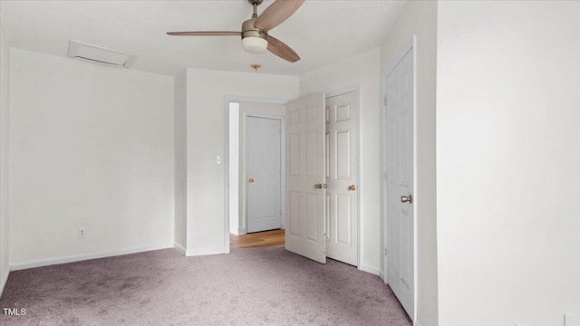 2396 Spring Valley Rd, Henderson, NC 27537 - unfurnished bedroom featuring carpet flooring, attic access, baseboards, and a ceiling fan