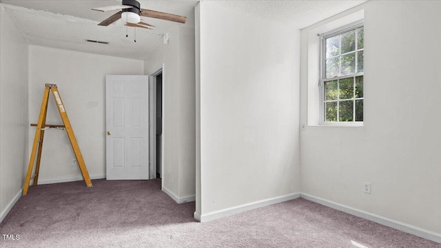 2396 Spring Valley Rd, Henderson, NC 27537 - carpeted spare room featuring a ceiling fan, baseboards, and a textured ceiling