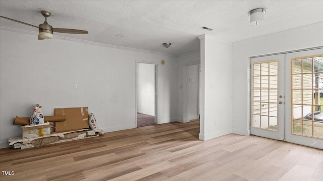 2396 Spring Valley Rd, Henderson, NC 27537 - unfurnished room featuring light wood-style flooring, crown molding, ceiling fan, french doors, and a textured ceiling