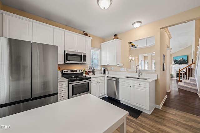1 Lake Hill Dr, Durham, NC 27713 - kitchen featuring stainless steel appliances, a sink, light countertops, white cabinets, and dark wood finished floors