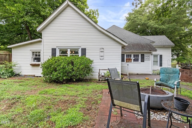 819 Corbin St, Albemarle, NC 28001 - back of house featuring a fire pit and roof with shingles