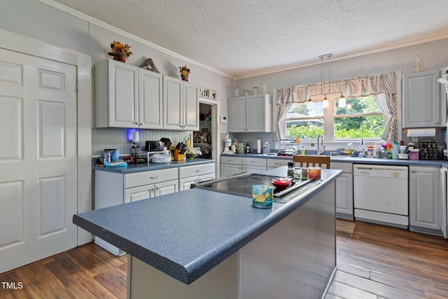 819 Corbin St, Albemarle, NC 28001 - kitchen with white dishwasher, a textured ceiling, dark wood-type flooring, ornamental molding, and a center island