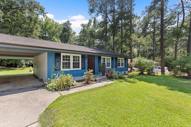509 Forest Ridge Rd, Garner, NC 27529 - view of front facade with driveway, a front yard, an attached carport, and view of scattered trees