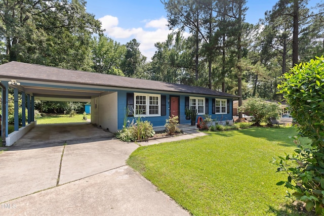 509 Forest Ridge Rd, Garner, NC 27529 - ranch-style house with concrete driveway, a front yard, a carport, covered porch, and view of wooded area
