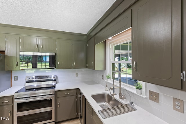 509 Forest Ridge Rd, Garner, NC 27529 - kitchen with stainless steel appliances, backsplash, light countertops, and a textured ceiling