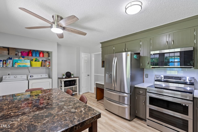 509 Forest Ridge Rd, Garner, NC 27529 - kitchen with appliances with stainless steel finishes, independent washer and dryer, green cabinets, light wood-style flooring, and a textured ceiling