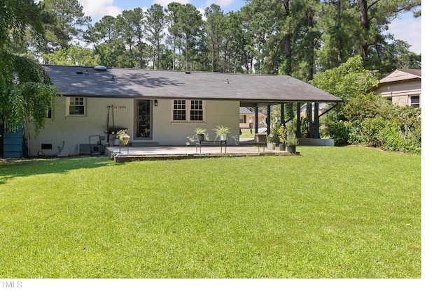 509 Forest Ridge Rd, Garner, NC 27529 - rear view of house featuring a patio, a lawn, and brick siding