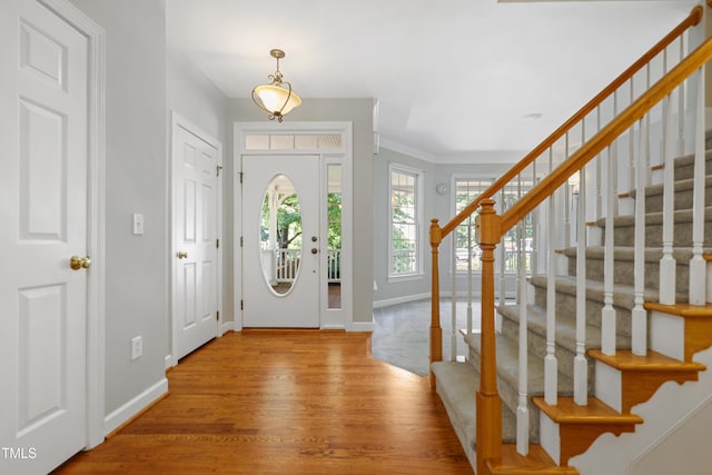 104 Shady Ridge Ct, Apex, NC 27502 - entryway featuring stairway, baseboards, wood finished floors, and crown molding